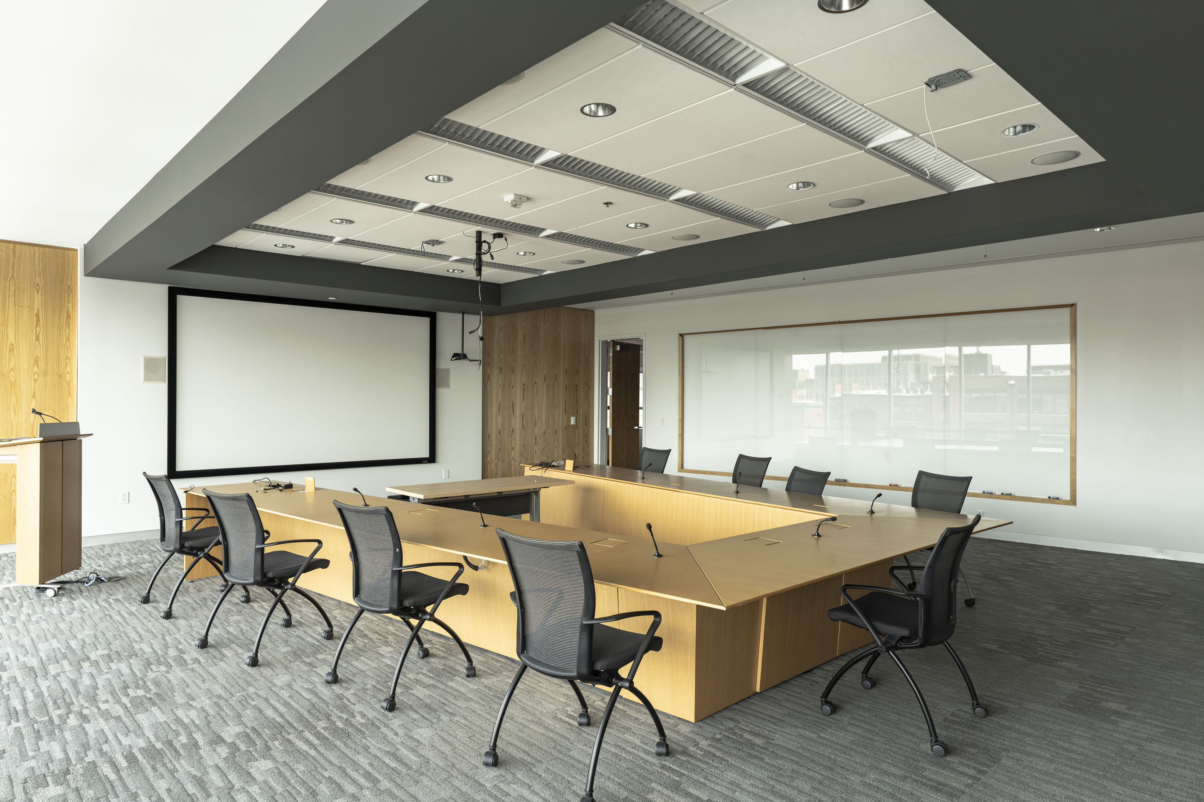Centennial Building large corporate conference room with U-shaped boardroom table, projector, and video conferencing equipment