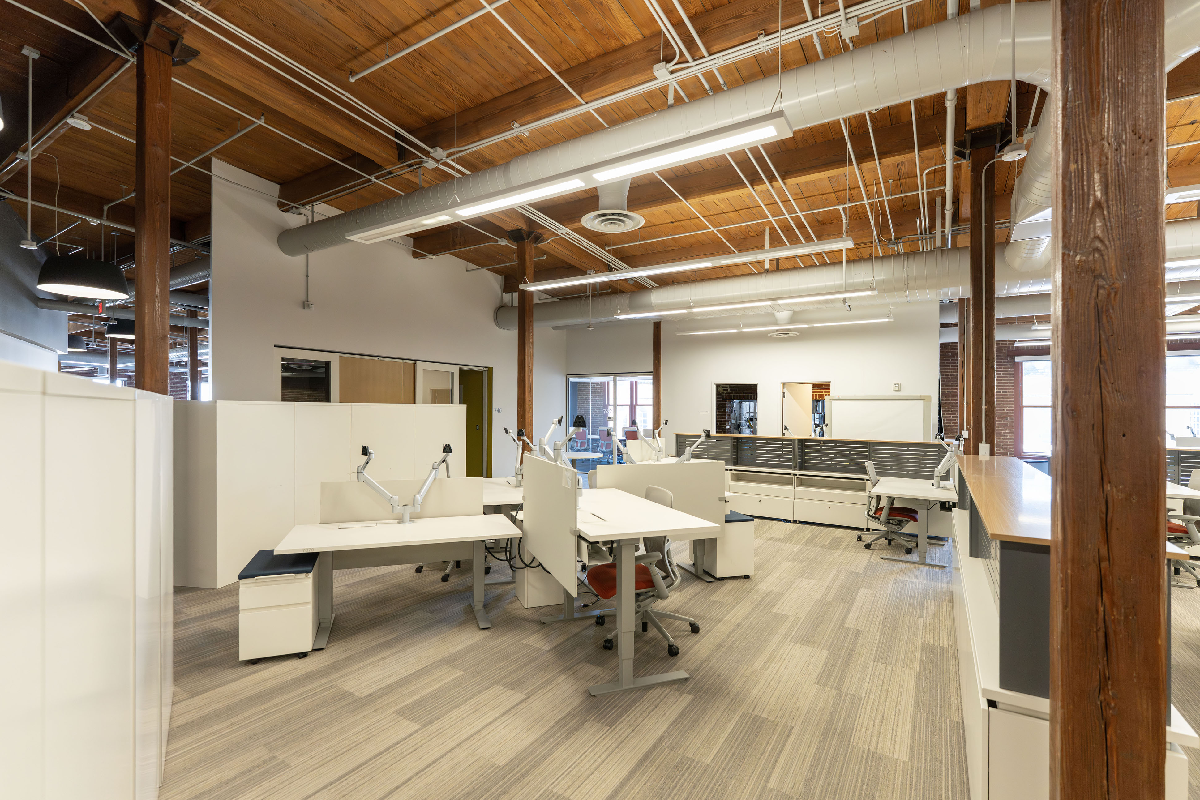 Open desk area with timber columns and natural light in the Poindexter Building 7th floor coworking space